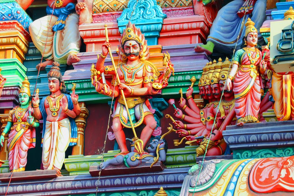 Vibrant statues depicting Hindu deities on a temple facade in Chennai, showcasing rich cultural art.