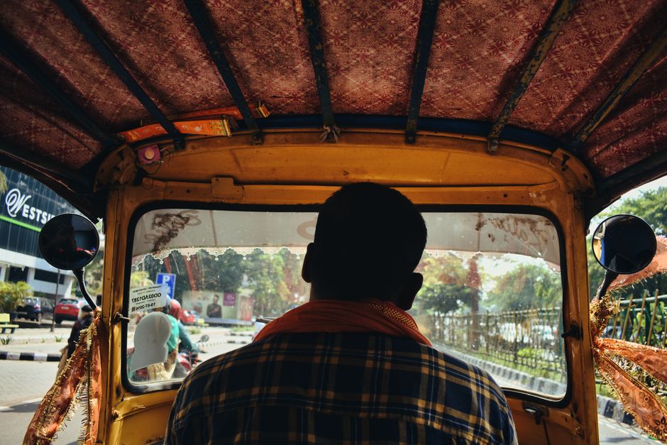 View from inside an auto rickshaw navigating city streets in Bhubaneswar, India.