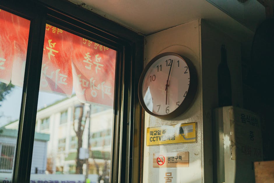 A vintage wall clock in a Seoul cafe with Korean signage, offering a unique cultural glimpse.