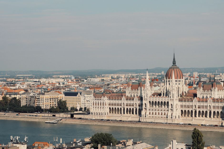 Scenic view of the iconic Hungarian Parliament Building along the Danube River in Budapest.
