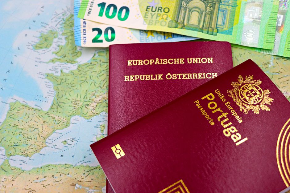 Austrian and Portuguese passports on a European map with euro banknotes.
