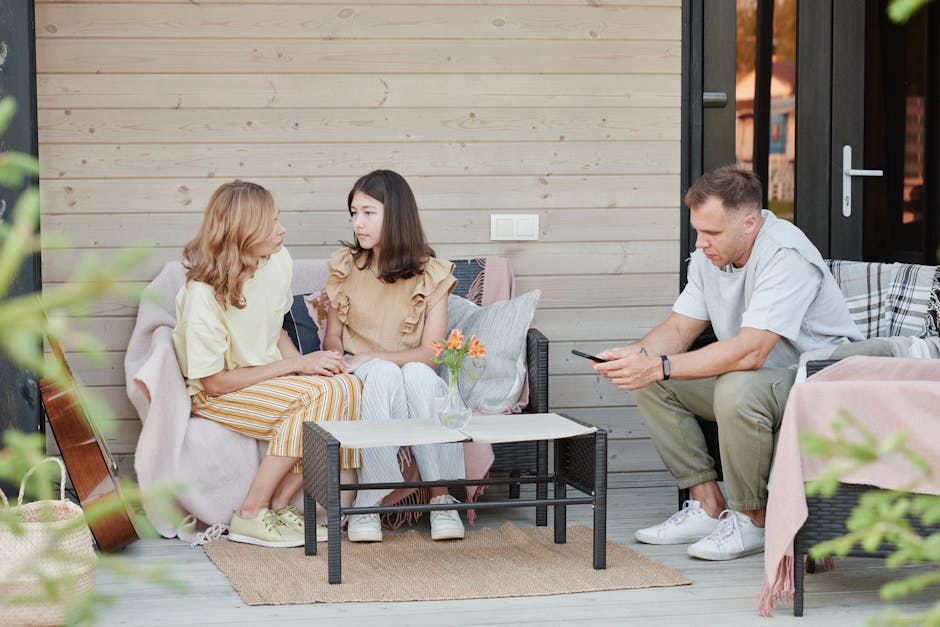 A family enjoying a relaxing day on their patio, engaging with digital devices.