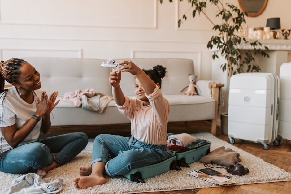 A joyful mother and daughter interacting at home while preparing luggage, filled with warmth and happiness.