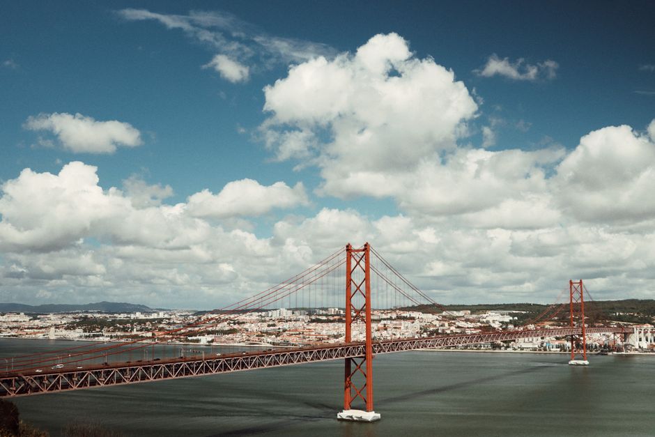 Scenic capture of the iconic 25 de Abril Bridge over the Tagus River in Lisbon, Portugal.