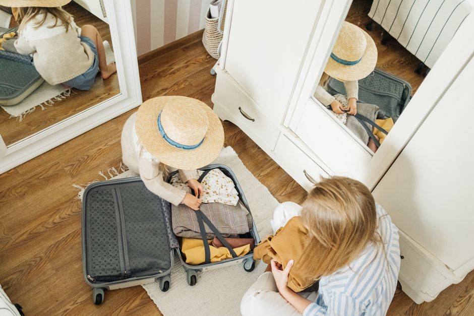 Packing clothes neatly into a carry-on suitcase