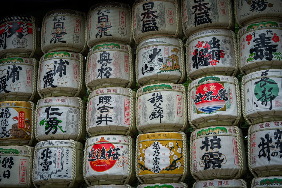 Traditional sake barrels with Japanese kanji, Kyoto temple display.