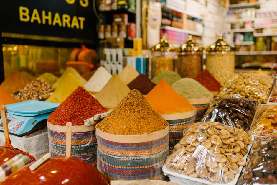 Colorful display of spices and dried fruits at a busy Istanbul market.