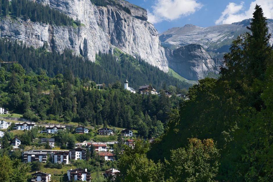 Picturesque village nestled in the Swiss Alps with beautiful mountain backdrop.
